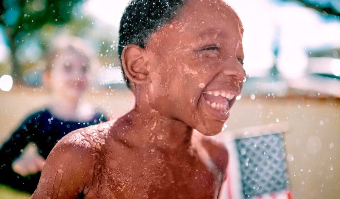 boy playing in the yard during summer