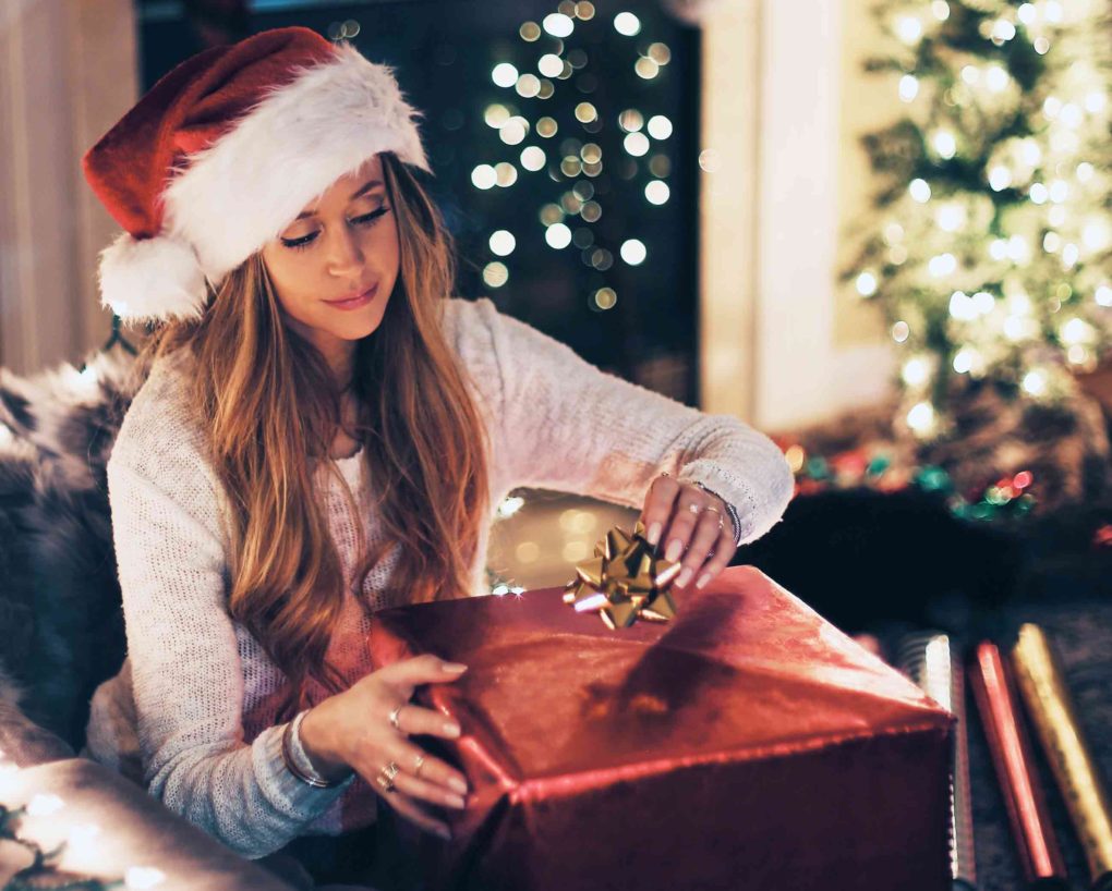 woman wrapping gifts for the holidays