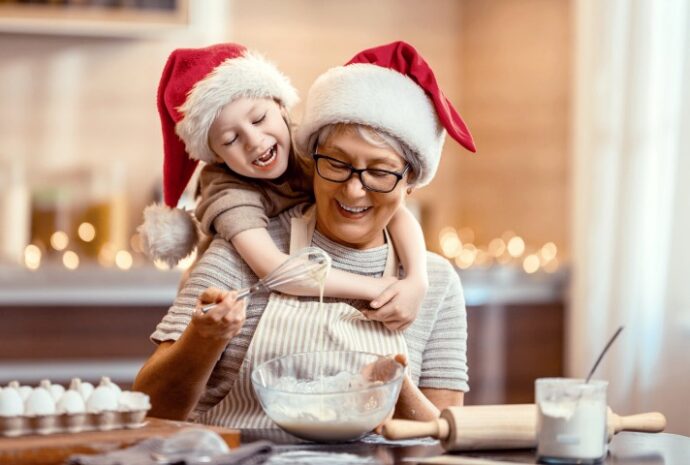 woman and granddaughter holiday baking at home