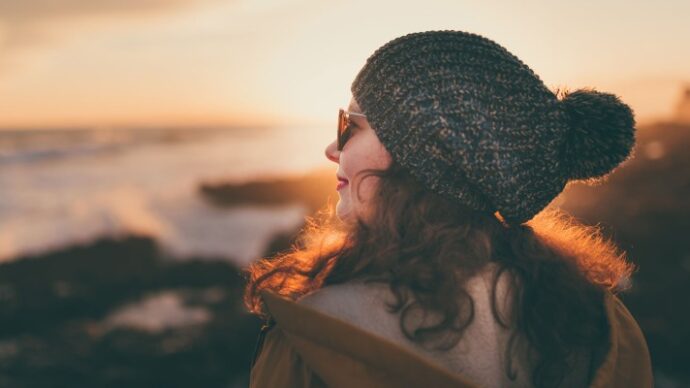 Woman embracing the winter weather at the local Long Island Beach