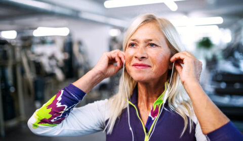 woman wearing headphones in her community gym