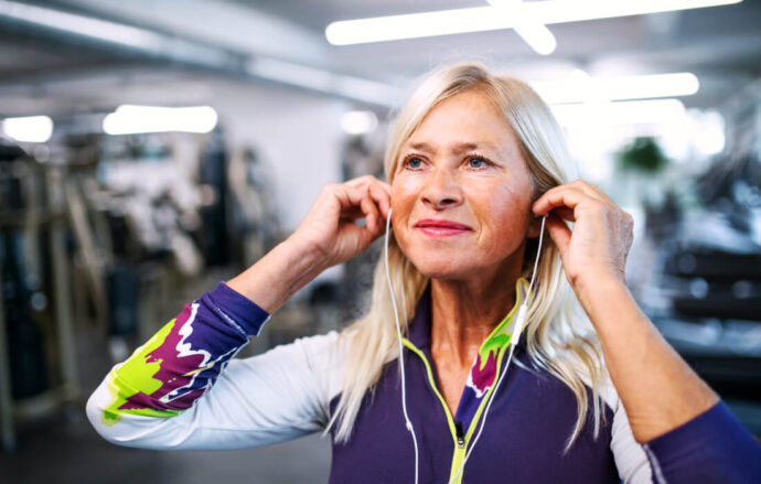 woman wearing headphones in her community gym