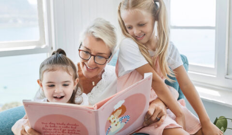 grandma reading children's book to grandkids